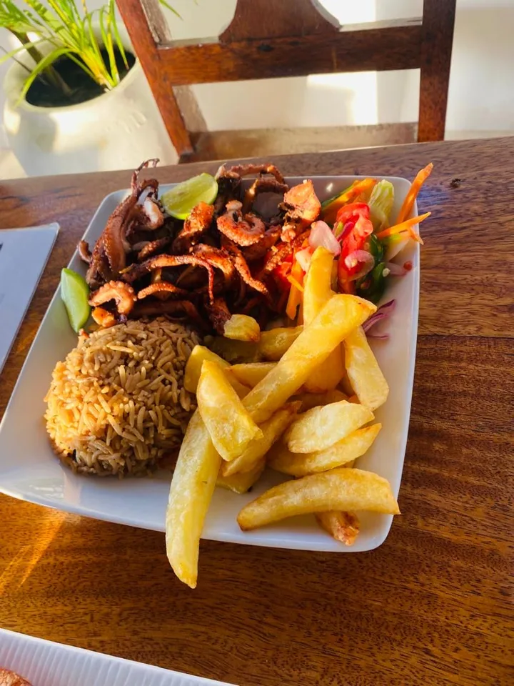 Grilled octopus with rice, chips and salad